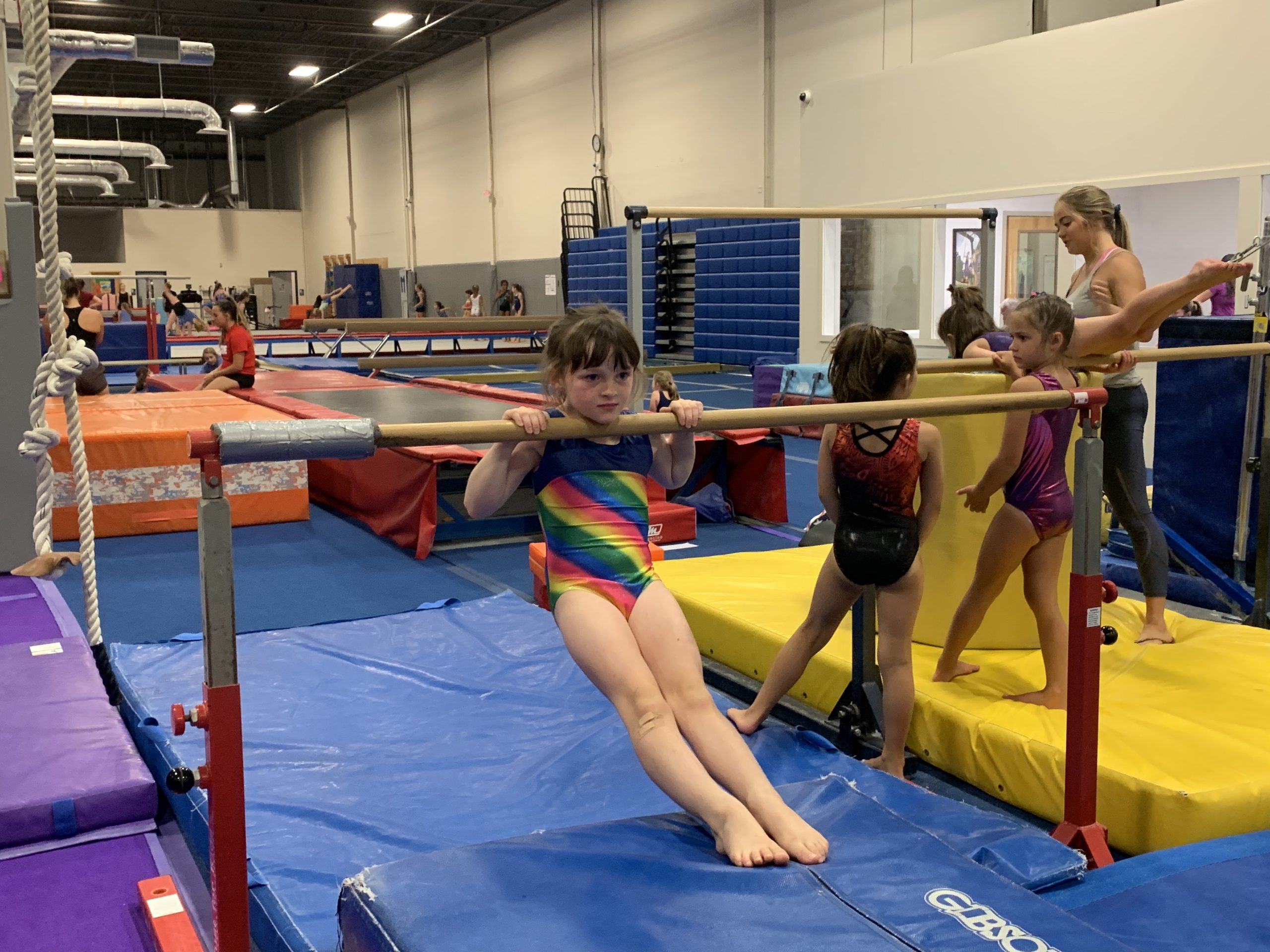 Girl on Bar at Legends Gymnastics in North Andover, MA.